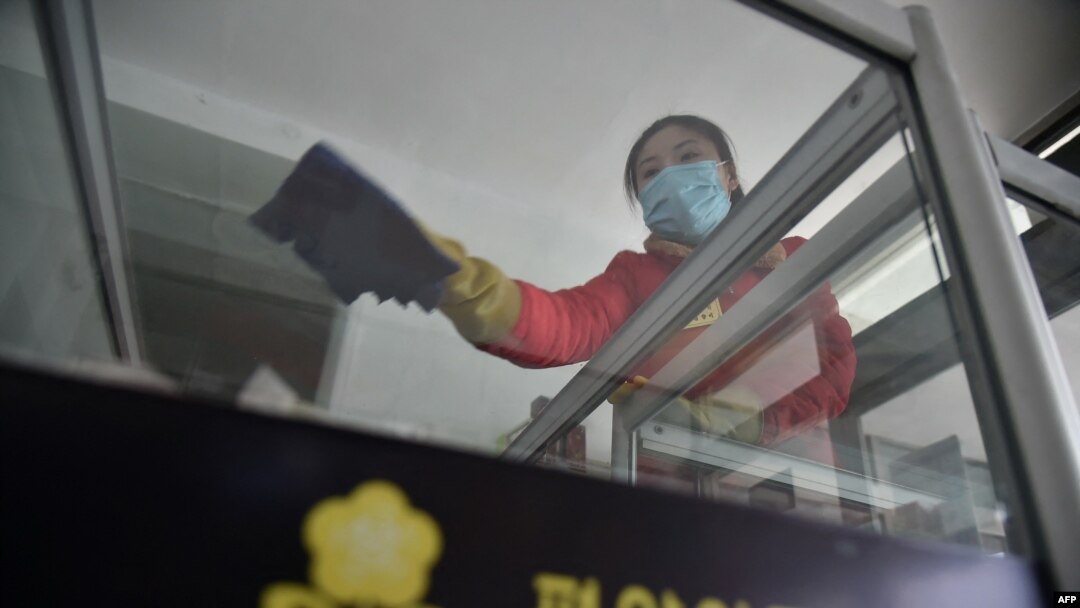 ARHIVA - Radnica dezinfikuje prostorije u Dečjoj robnoj kući u Pjongjangu, 18. marta 2022. (Foto: AFP/Kim Won Jin)