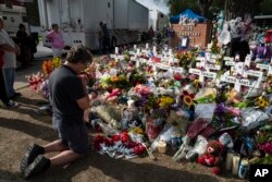 Salvatore Di Grazia, a teacher from Rio Grande Valley, Texas, visits a memorial at Robb Elementary School in Uvalde, Texas, May 30, 2022, for the victims killed in last week's school shooting. (AP Photo/Jae C. Hong)