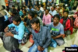 Rohingya refugees wait at a temporary shelter in Pidie, Aceh province, Indonesia, December 26, 2022, in this photo taken by Antara Foto. (Antara Foto/Joni Saputra/via REUTERS)