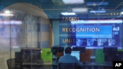 Employees work at the Facial Recognition Unit at the Hyderabad Police Headquarters in Hyderabad, India. (AP Photo/Mahesh Kumar A.)