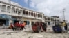 Rescuers carry an unidentified injured man from the scene of an explosion in front of Dayah hotel in Somalia's capital Mogadishu, Jan. 25, 2017.