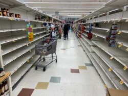 Shelves stand almost empty at a department store in Washington, D.C., March 15, 2020. REUTERS/Gavino Garay