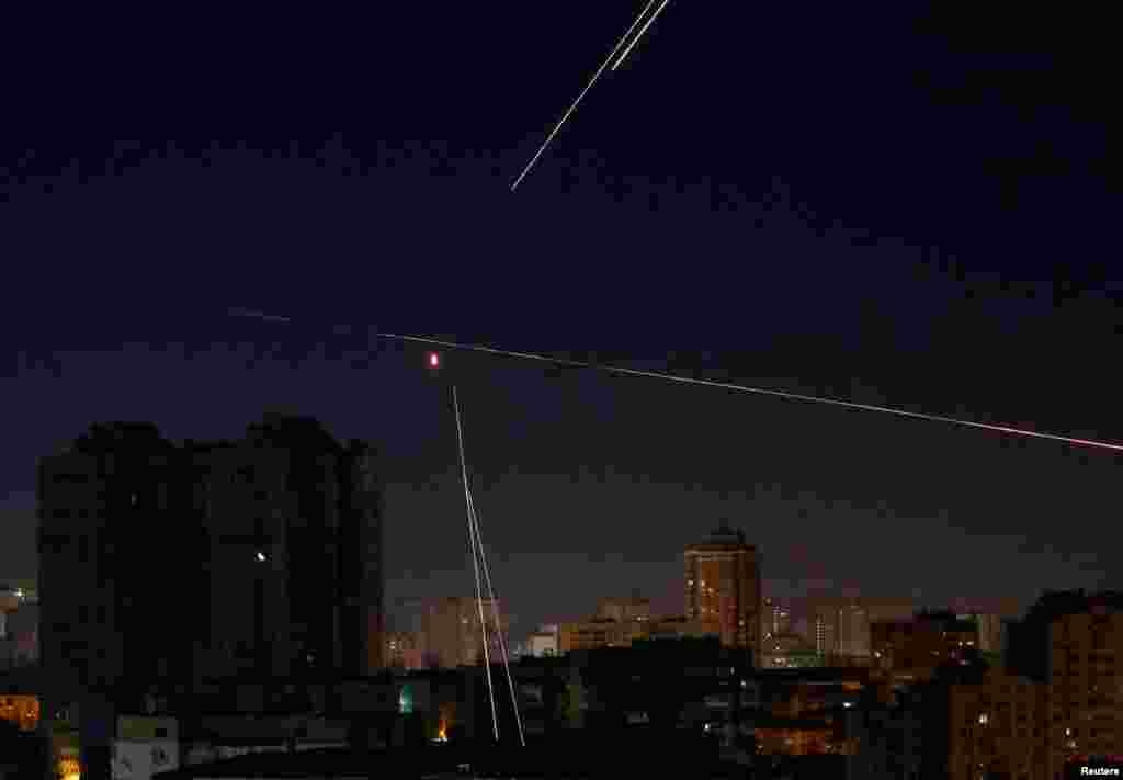 Tracers are seen in the night sky as Ukrainian servicemen fire on a drone in Kyiv, Ukraine, March 14, 2022.