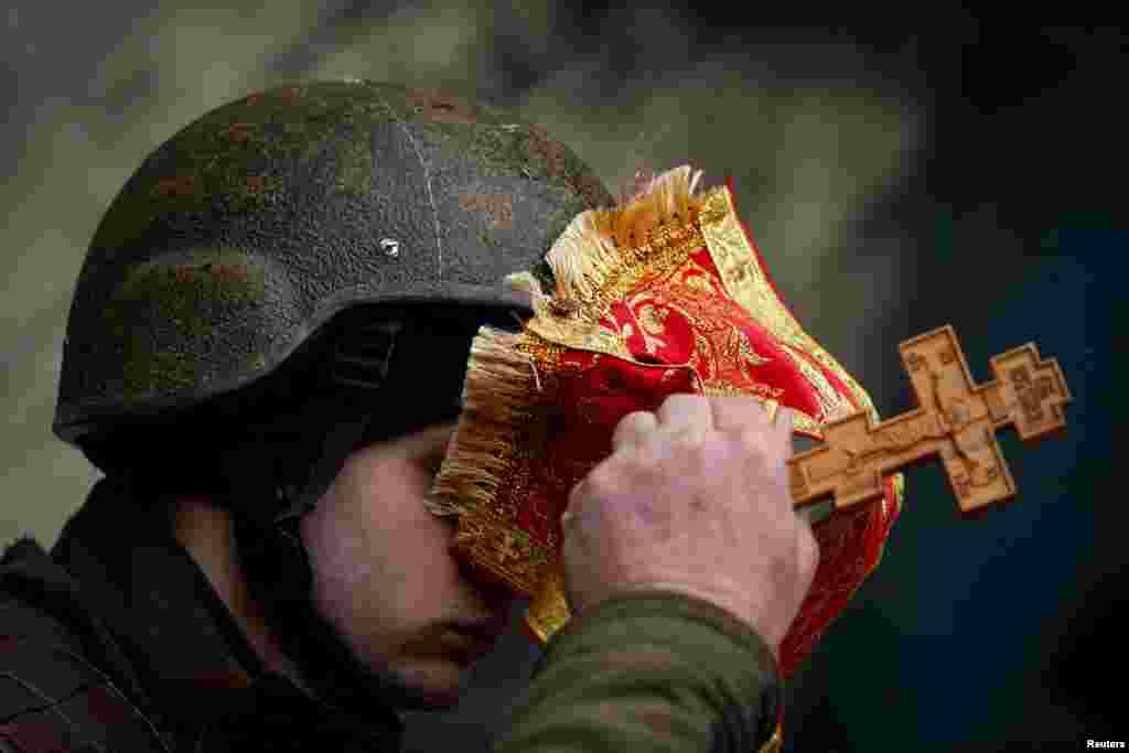 Military Chaplain Nikolay Medynsky blesses a Ukrainian soldier before he is deployed to the frontline, as Russia&#39;s attack on the Ukraine continues, in Kyiv.