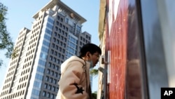 FILE - A man gets swabbed for COVID test near a building of the Peking University in Beijing, Wednesday, Nov. 16, 2022. (AP Photo/Ng Han Guan)