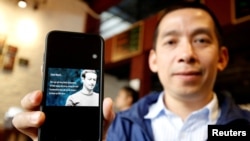 Vietnamese Facebooker and human rights activist, La Viet Dung, shows the open letter signed by himself sent to Facebook Inc.'s chief executive Mark Zuckerberg, in Hanoi, Vietnam, April 10, 2018.