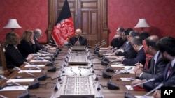 In this photo released by the Afghan Presidential Palace, Afghan President Ashraf Ghani, center, speaks to U.S. peace envoy Zalmay Khalilzad, third left, at the presidential palace in Kabul, Afghanistan, Jan. 28, 2019.
