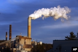FILE - Steam billows from the coal-fired Merrimack Station in Bow, N.H., Jan. 20, 2015.