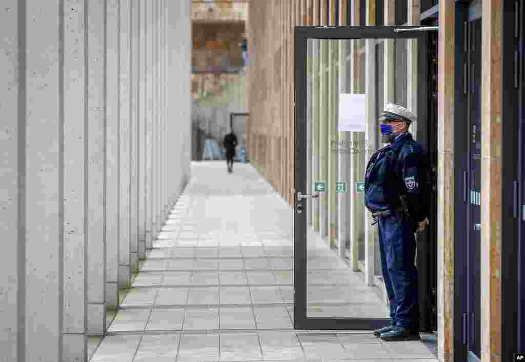 A police officer guards the entrance of a vaccine center that was introduced to the media in Wiesbaden, Germany.
