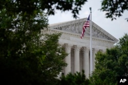 An American flag waves in front of the U.S. Supreme Court building, Monday, June 27, 2022, in Washington. (AP Photo/Patrick Semansky)