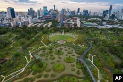 An aerail view shows the water features of Benjakitti Park in Bangkok, Thailand, Sunday, May 8, 2022. (AP Photo/Krit Phromsakla Na Sakolnakorn)