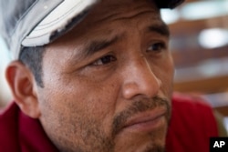 Mynor Cardona, Yenifer Yulisa Cardona Tomás' father, listens to a question during an interview in Guatemala City, Monday, July 4, 2022. (AP Photo/Oliver de Ros)