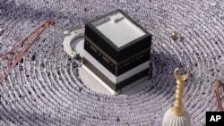FILE - Muslim pilgrims pray around the Kaaba, the cubic building at the Grand Mosque, during the annual Hajj pilgrimage in Mecca, Saudi Arabia, on June 25, 2023. (AP Photo/Amr Nabil, File)