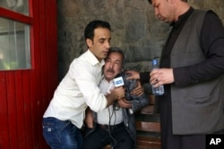 A man cries at a hospital after he lost his Journalist son in explosions in Kabul, Afghanistan, Monday, April 30, 2018.