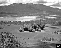 This 1968 photo provided by the U.S. Geological Survey Astrogeology Science Center shows craters being created in a volcanic cinder field east of Flagstaff, Ariz.