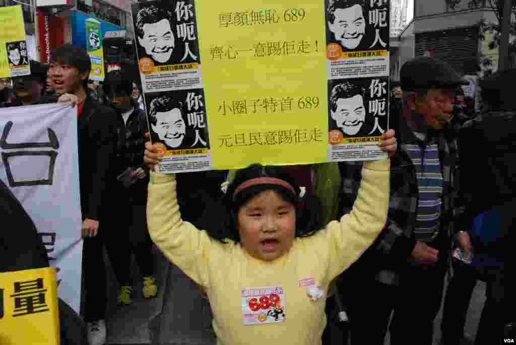 7歲的林小妹妹高舉標語,諷刺特首梁振英說謊,要求他下台(美國之音湯惠芸攝)