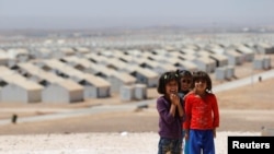 Syrian refugee children pose before the visit of actress Angelina Jolie to hold a news conference at Azraq refugee camp for Syrians displaced by conflict, near Al Azraq city, Jordan, Sept. 9, 2016. 