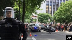 FILE - Thousands of protesters gather in Portland, Ore., for competing rallies following last month's fatal stabbing of two men on a light-rail train by a man police say was shouting anti-Muslim slurs. Marches against Islamic law are scheduled in more tha