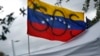 A Venezuela flag is flown with a painted "SOS" during a rally at the El Arepazo Doral Venezuelan restaurant, in Doral, Fla., May 1, 2019.