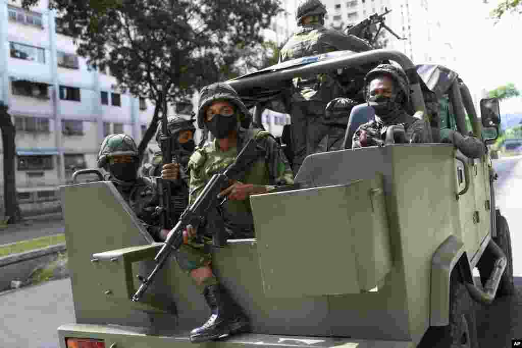 Soldiers patrol on a military vehicle during elections to choose members of the National Assembly in Caracas, Venezuela.&nbsp;The vote, championed by President Nicolas Maduro, is rejected as fraud by the nation&#39;s most influential opposition politicians.