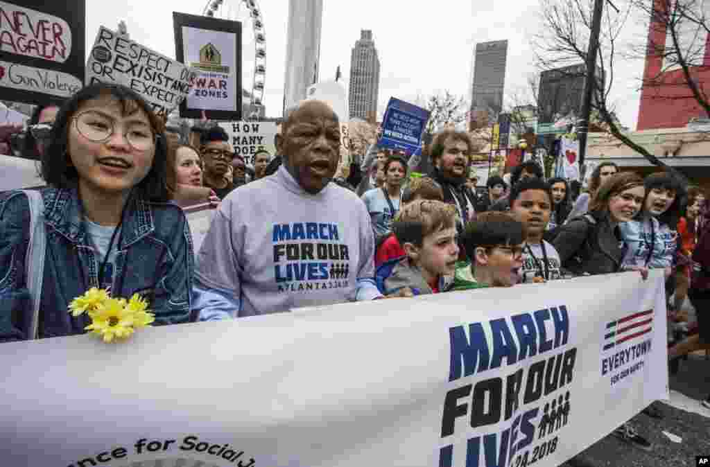 U.S. Rep. John Lewis leads a march of thousands through the streets of Atlanta on Saturday, March 24, 2018. 