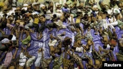 Migrants believed to be Rohingya rest inside a shelter after being rescued from boats at Lhoksukon in Indonesia's Aceh Province May 11, 2015. (REUTERS/Roni Bintang)