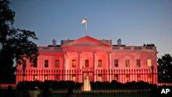 The White House in Washington is bathed in pink light to celebrate Breast Cancer Awareness Month.