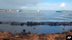 This photo taken and provided by Sophie Seneque, shows oil polluting the foreshore of the public beach in Riviere des Creoles, Mauritius, Saturday Aug. 8, 2020, after it leaked from the MV Wakashio, a bulk carrier ship that recently ran aground off the so