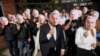 Simpatizantes del expresidente de Colombia Álvaro Uribe sostienen recortes de su retrato afuera del tribunal donde asiste a una audiencia por cargos de manipulación de testigos y soborno en Bogotá, Colombia, el lunes 10 de febrero de 2025. AP