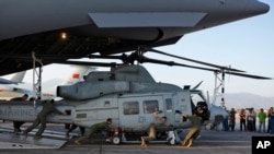 US soldiers unload Huey helicopters from a US Air Force Boeing C-17 Globemaster III after the same landed in Kathmandu, Nepal, Sunday, May 3, 2015. 