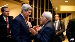 Secretary of State John Kerry talks with Iranian Foreign Minister Mohammad Javad Zarif in Vienna, after the International Atomic Energy Agency (IAEA) verified that Iran has met all conditions under the nuclear deal.