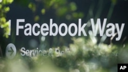 In this April 25, 2019 file photo, an address sign for Facebook Way is shown in Menlo Park, Calif. (AP Photo/Jeff Chiu, File)