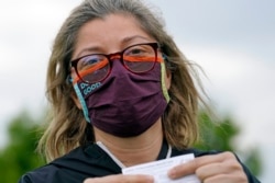 Alejandra poses with her vaccination card after getting her second Moderna COVID-19 shot Monday April 19, 2021, in Pasadena, Texas.