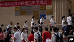 FILE - Students line up to enter a school for the first day of China's national college entrance examinations, known as the gaokao, in Beijing, Tuesday, June 7, 2022. (AP Photo/Andy Wong, File )