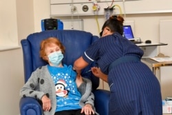 Margaret Keenan, 90, is the first patient in Britain and the world to receive the Pfizer-BioNTech COVID-19 vaccine, at University Hospital, Coventry, England, Dec. 8, 2020.