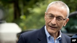 Hillary Clinton campaign chairman John Podesta speaks to members of the media outside Clinton's home in Washington, Oct. 5, 2016.