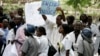 FILE - Zimbabwean riot policemen stand in front of doctors and nurses who are demonstrating over the deteriorating health system, outside Parirenyatwa group of hospitals in Harare, Nov. 18, 2008.