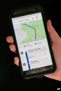 In this Wednesday, Aug. 8, 2018, photo a mobile phone displays a user's travels in New York. (AP Photo/Seth Wenig)