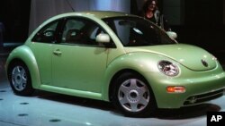The redesigned Volkswagen Beetle is on display after its unveiling at the North American International Auto Show in Detroit on Monday, Jan. 5, 1998.(AP Photo/Carlos Osorio)