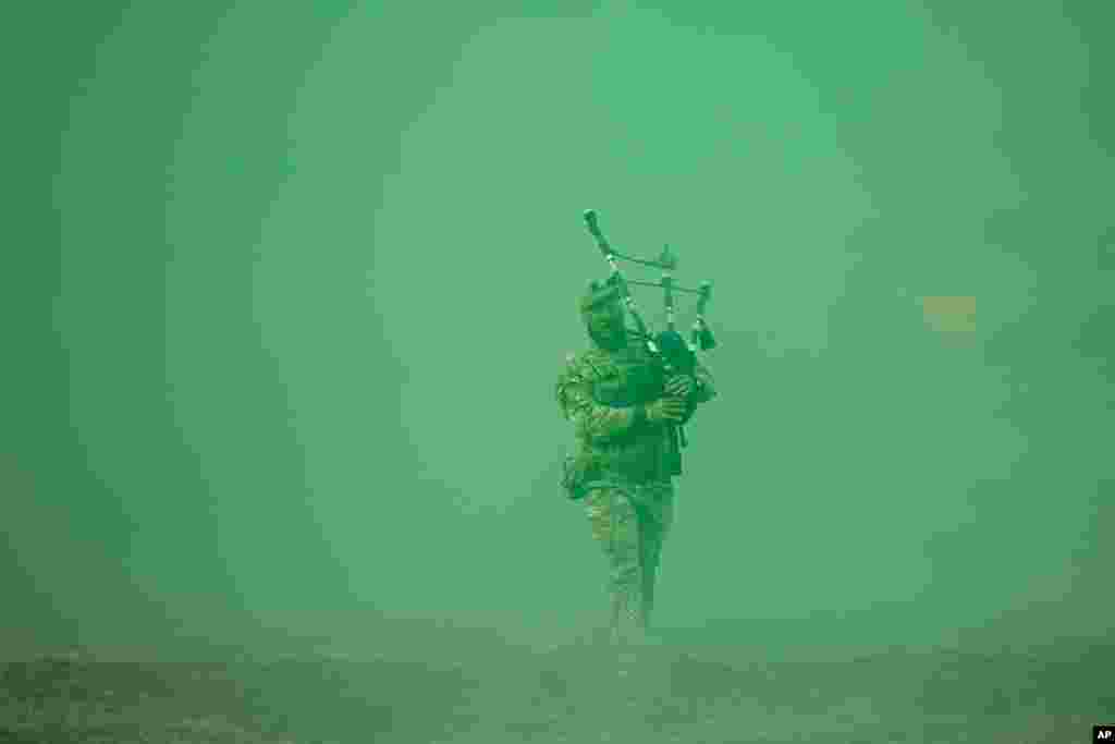 Lance Corporal Jamie Killorn of the 4 SCOTS The Highlanders Company plays the pipe at the end of the Steadfast Dart 2025 exercise, involving some 10,000 troops from nine nations and representing the largest NATO operation planned this year, at a training range in Smardan, eastern Romania.