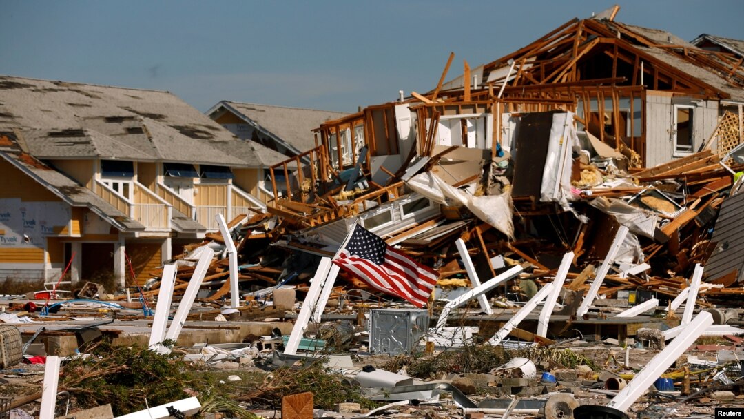 An American flag flies amongst rubble left in the aftermath of Hurricane Michael in Mexico Beach, Florida, Oct. 11, 2018.