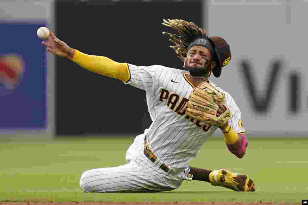 San Diego Padres shortstop Fernando Tatis Jr. throws late to first as Pittsburgh Pirates' Adam Frazier arrives safely for a single during the third inning of a baseball game May 5, 2021, in San Diego, California.