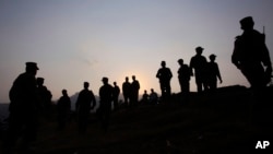 FILE - Pakistan army soldiers gather at a forward area post on the Line of Control (LOC) that divides Kashmir between Pakistan and India, in Tatta Pani, some 200 km, from Islamabad, Pakistan, Oct. 1, 2016. On Monday, Nov. 14, 2016, Pakistan's army claimed