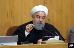 In this photo released by official website of the office of the Iranian Presidency, President Hassan Rouhani speaks in a cabinet meeting in Tehran. Dec. 31, 2017. After a wave of economic protests swept major cities in Iran, President Rouhnai said that pe
