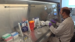 A technician inspects vials of coronavirus disease (COVID-19) vaccine candidate BNT162b2 at a Pfizer manufacturing site in manufacturing site in St. Louis, Missouri, U.S. in an undated photograph. (Pfizer/Handout via REUTERS)