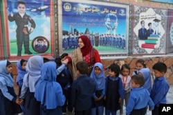 Hameeda Danesh meets with children during her parliamentary campaign.