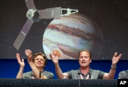 Scott Bolton, left, and Rick Nybakken celebrate Juno starting its orbit of Jupiter.