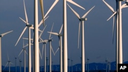 In this file photo, a wind turbine farm owned by PacifiCorp near Glenrock, Wyoming, cranks out electricity, May 6, 2013.