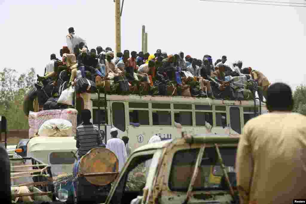 People ride on a bus as they return to their families ahead of the Eid al-Adha festival in Khartoum, Sudan.