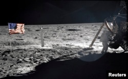 This NASA file image shows U.S. astronaut Neil Armstrong, the Apollo 11 Mission Commander, standing next to the Lunar Module "Eagle" on the moon July 20, 1969.